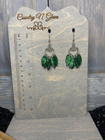 Shimmer green petals on silver heart chandelier drops.