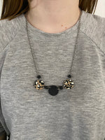 Black & white leopard on nude with matte black necklace